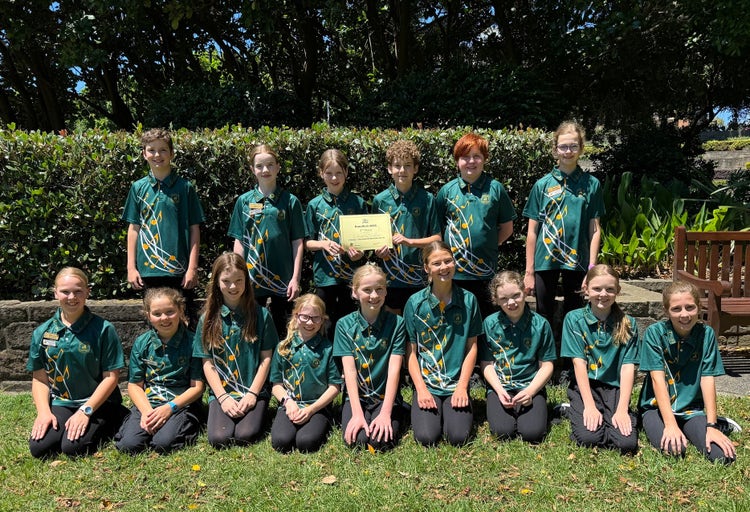 students-from-school-band-dressed-in-band-t-shirts-holding-award